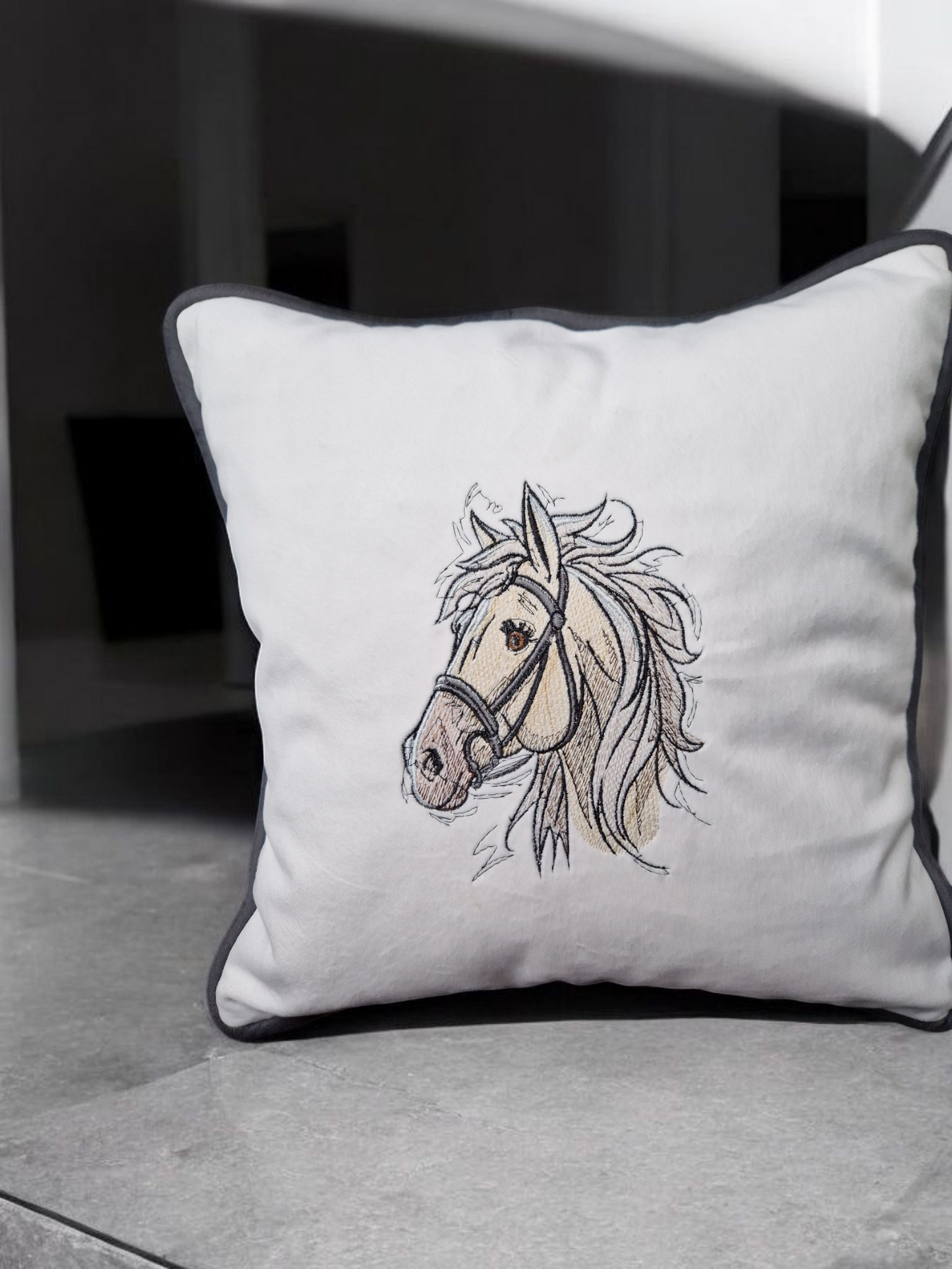 Embroidered cushion with a horse motif