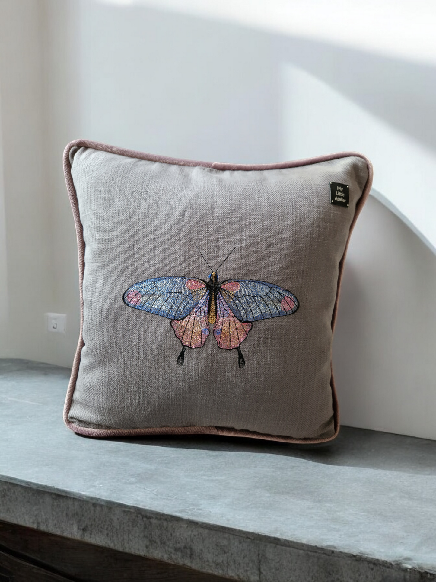 Embroidered cushion with "butterfly" motif