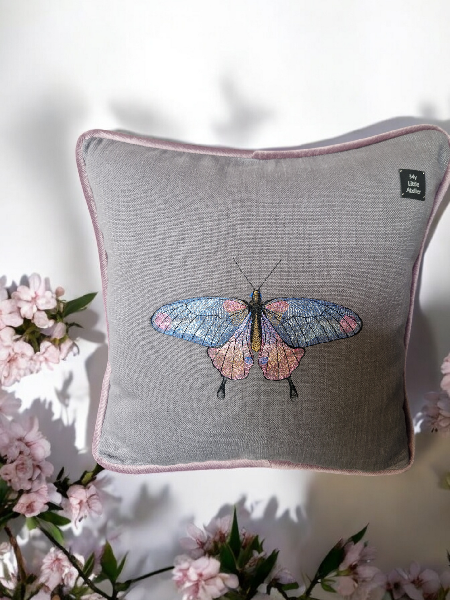 Embroidered cushion with "butterfly" motif