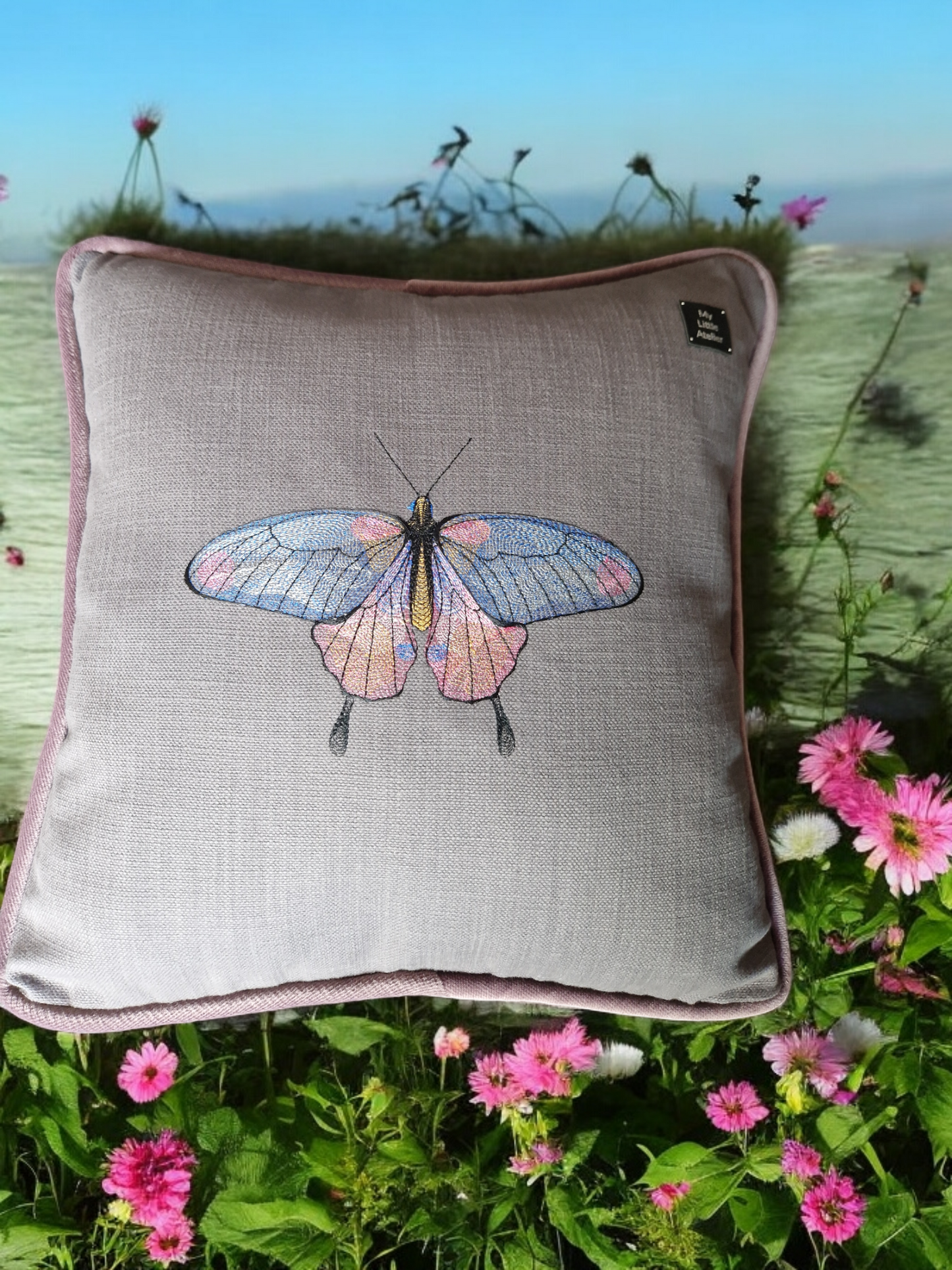 Embroidered cushion with "butterfly" motif