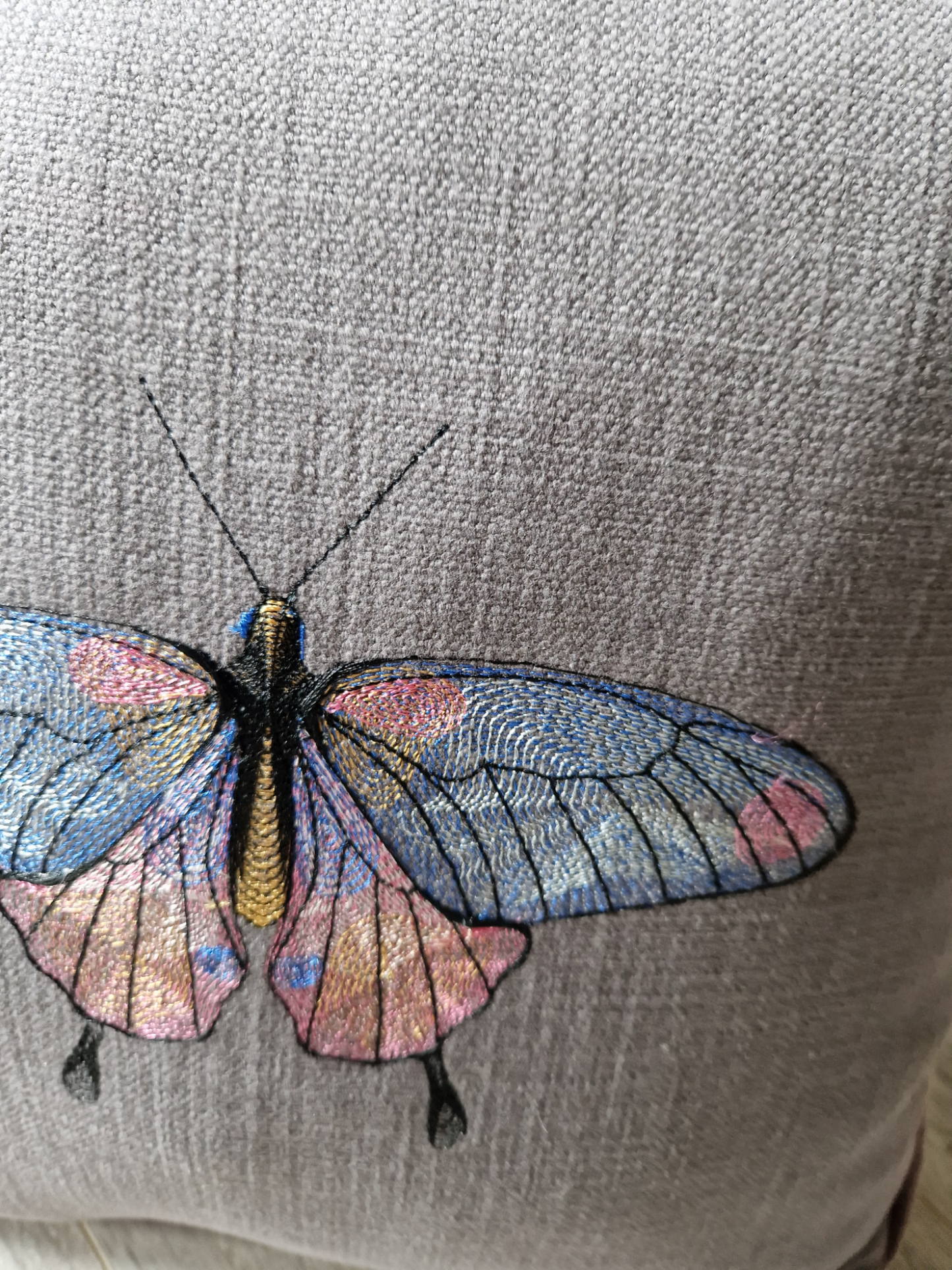 Embroidered cushion with "butterfly" motif