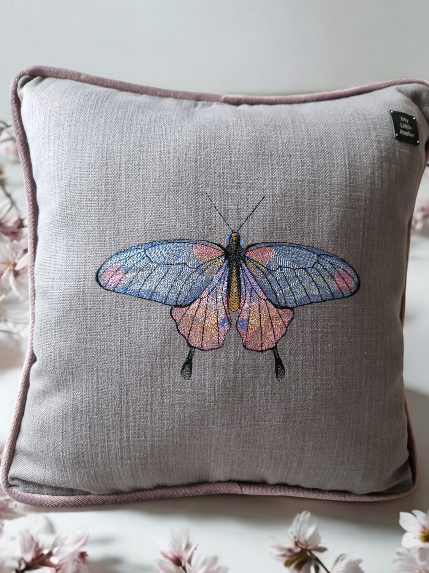 Embroidered cushion with "butterfly" motif