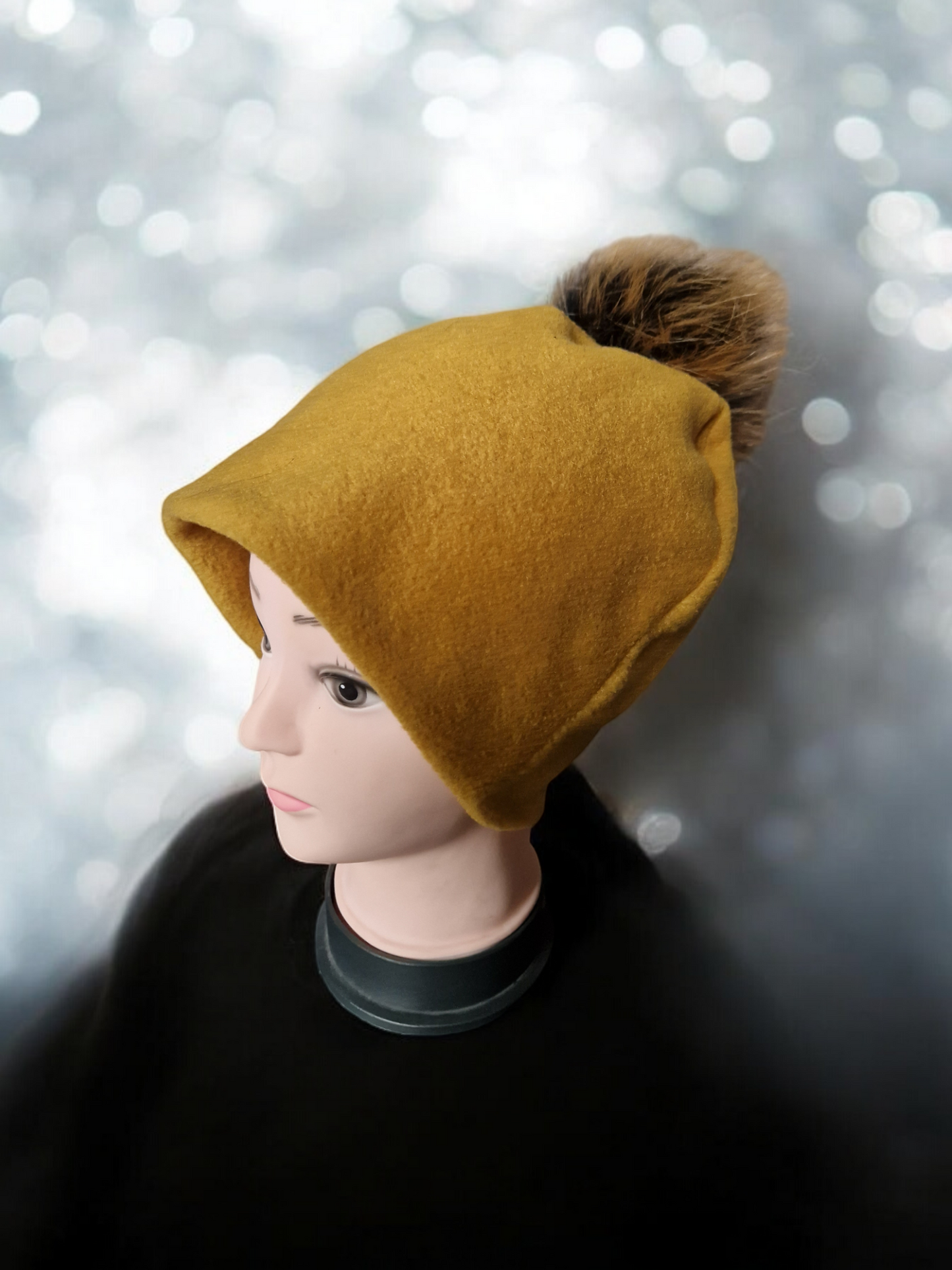 Mustard women's fleece hat with brown fur pompom.