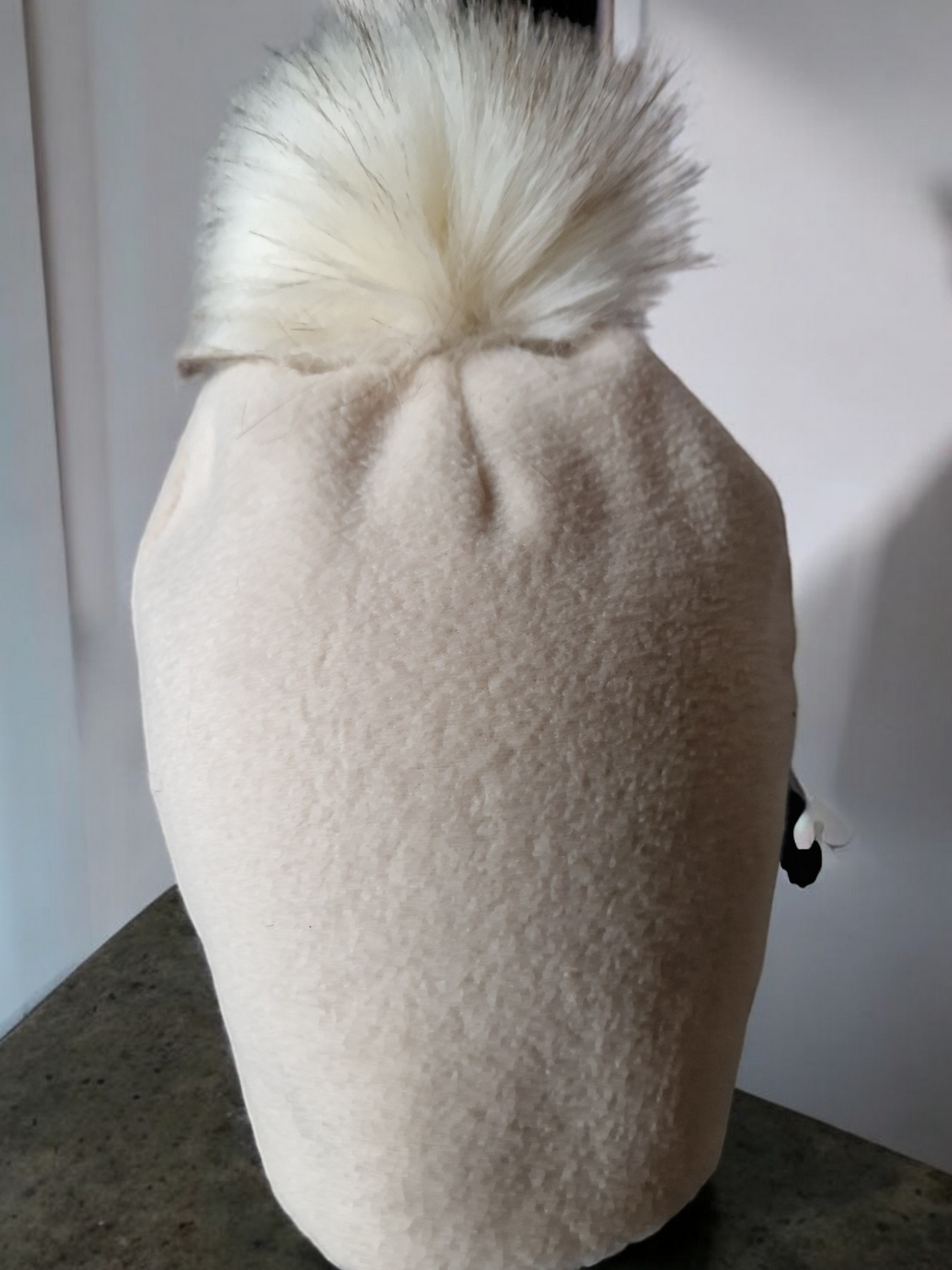 Cream beige women's fleece hat with cream fur pompom.