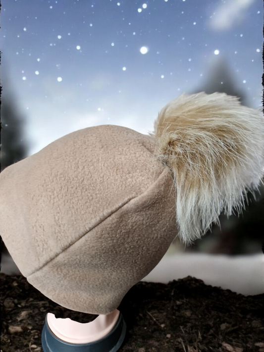 Carmel beige women's fleece hat with carmel fur pompom.