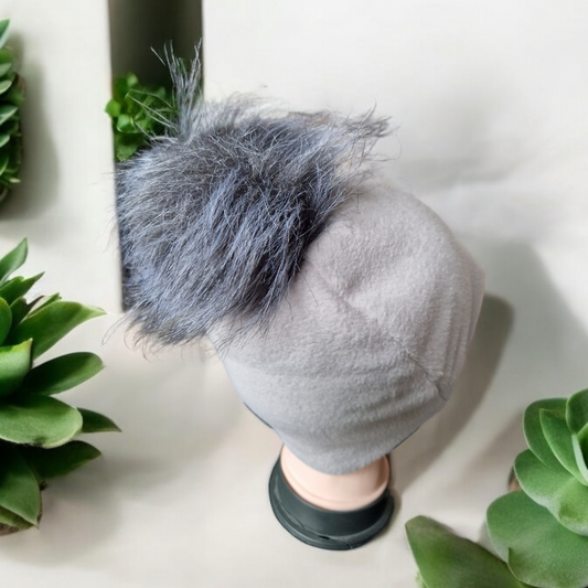 Light grey women's fleece hat with grey fur pompom.