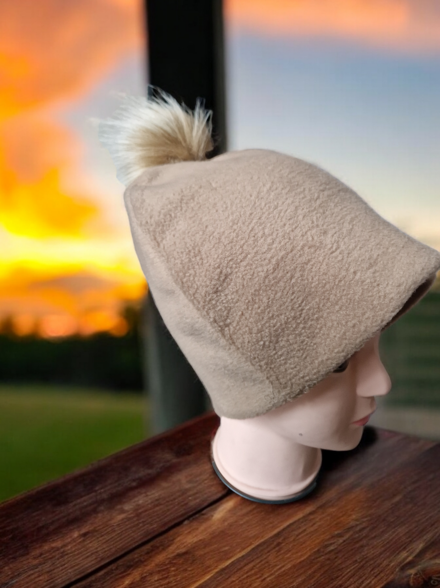 Carmel beige women's fleece hat with carmel fur pompom.