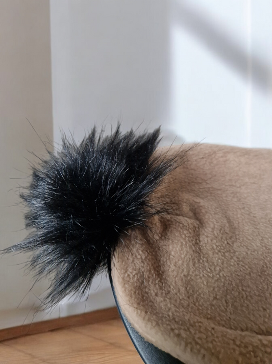 Carmel beige women's fleece hat with black fur pompom.