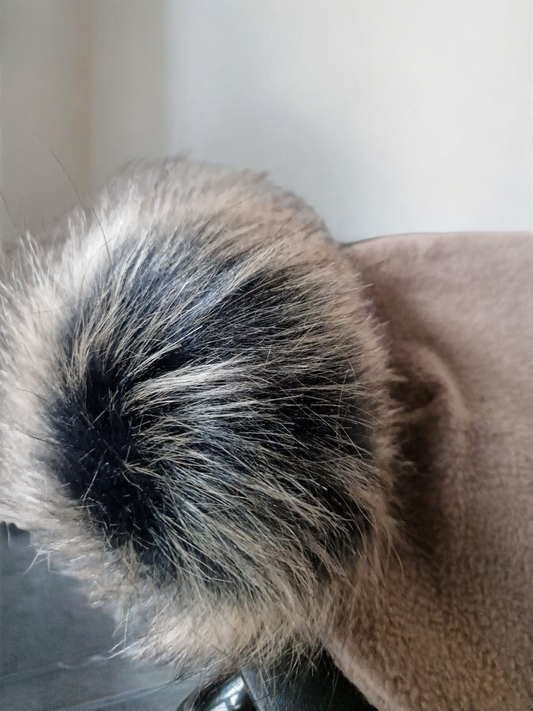 Beige women's fleece hat with beige fur pompom.