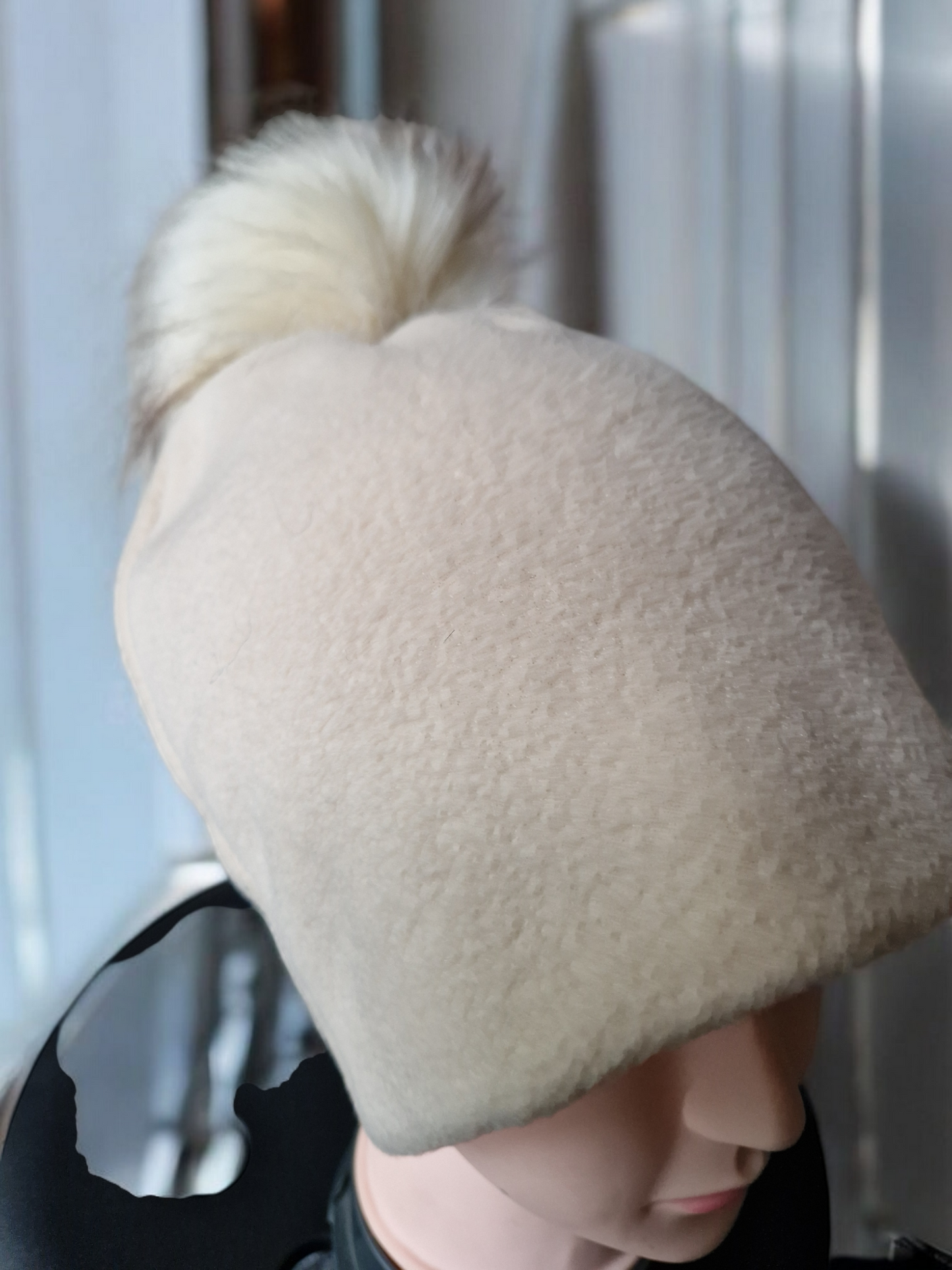 Cream beige women's fleece hat with cream fur pompom.