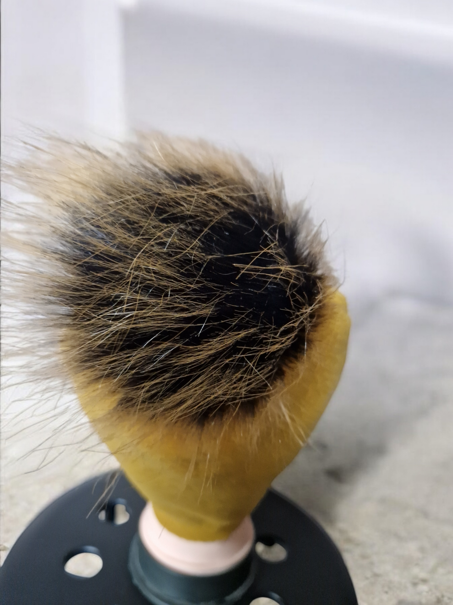 Mustard women's fleece hat with brown fur pompom.