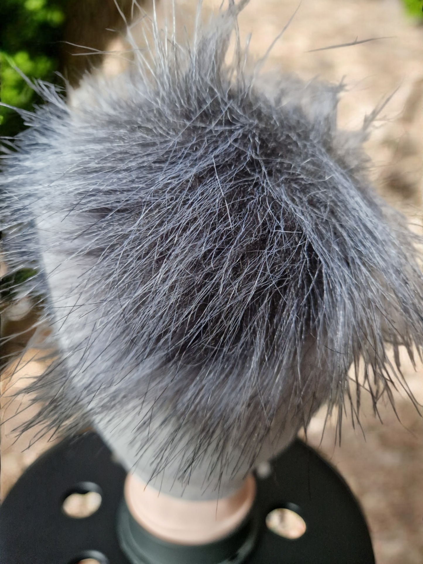 Light grey women's fleece hat with grey fur pompom.