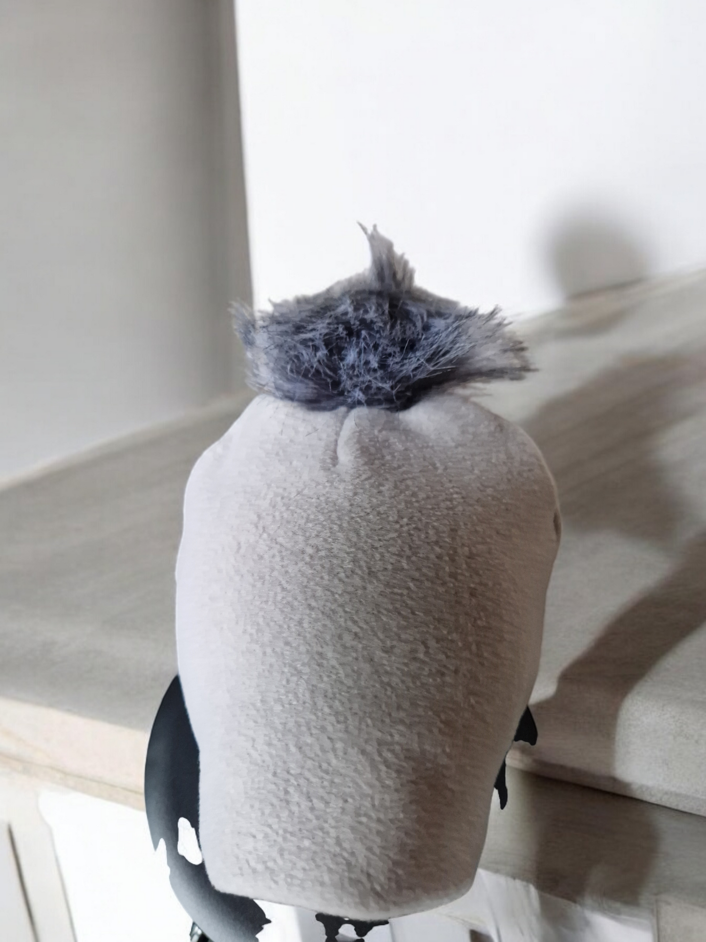 Light grey women's fleece hat with grey fur pompom.