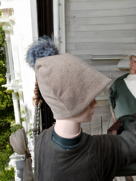 Beige women's fleece hat with grey fur pompom.