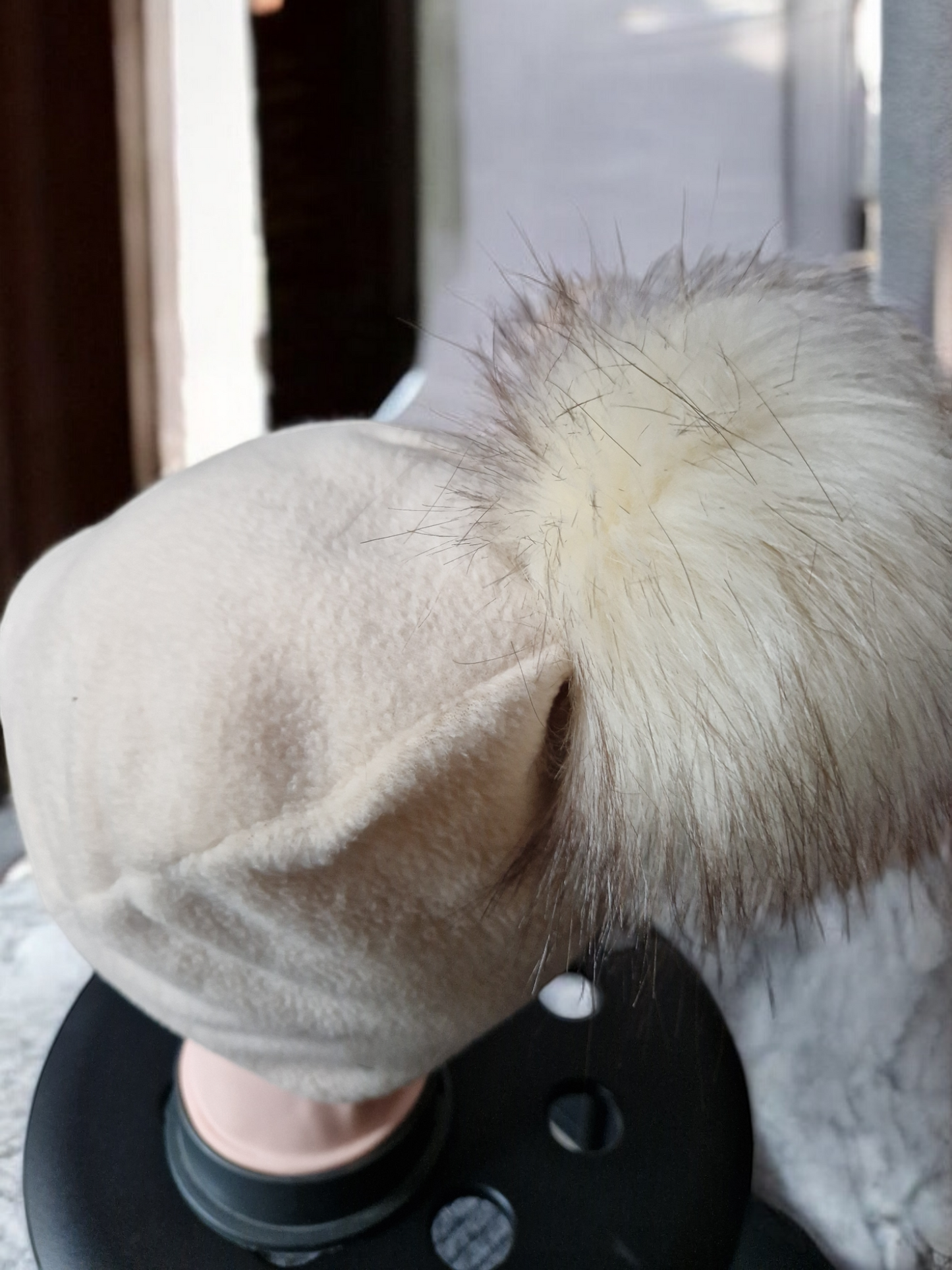 Cream beige women's fleece hat with cream fur pompom.